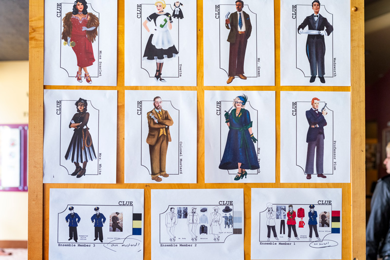A colorful display of various costumes on a drawing board