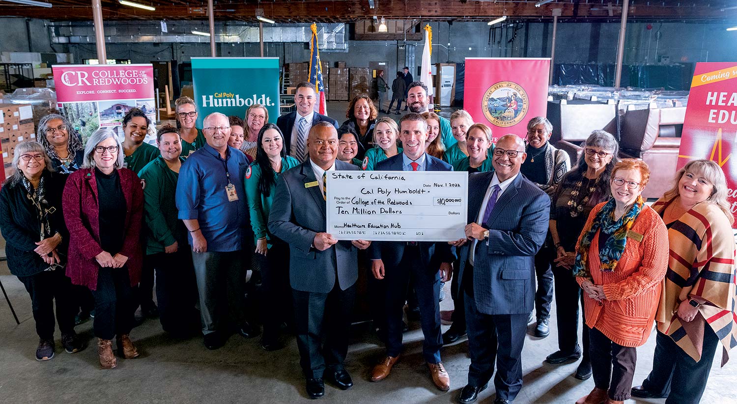 (FRONT ROW) Senate Majority Leader Mike McGuire (CENTER) joins College of the Redwoods President Keith Flamer (RIGHT) and Cal Poly Humboldt President Tom Jackson, Jr. (LEFT) to celebrate the $10 million investment to transform a warehouse on Samoa Boulevard
                        in Arcata into a state-of-the-art learning lab.
