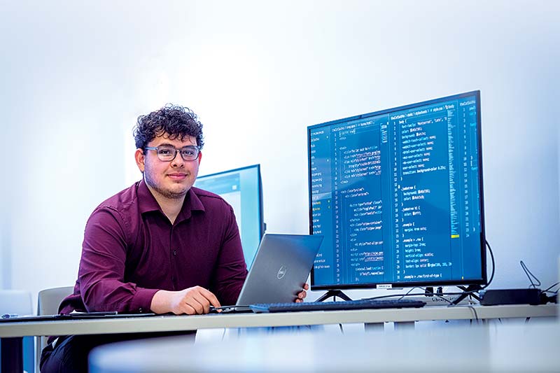 Victor Diaz sitting at computer