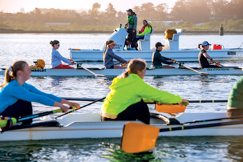 students on the water rowing