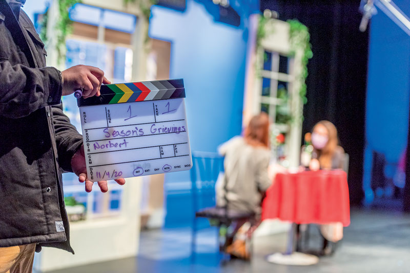 scene marker in focus in front of two people sitting at a table