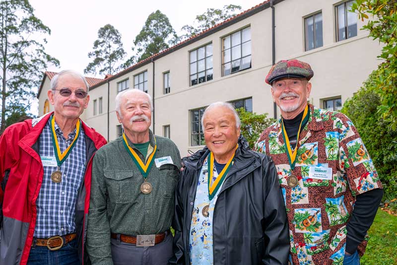 (From left to right): Kevin Dempsey, Larry Ford, Randy Ishihara, and Bob McKenzie recreating their commencement photo at the 2024 Golden Graduate luncheon outside of Founders Hall.