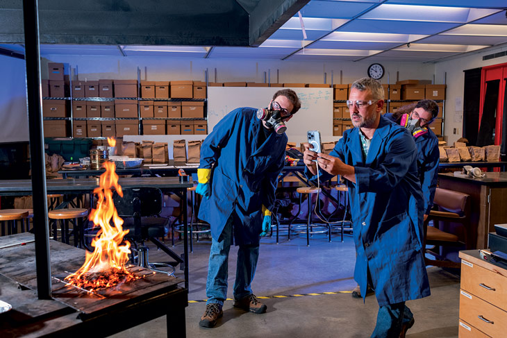 students with professor in the fire lab