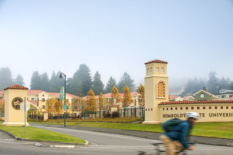 front of campus with a blurred biker