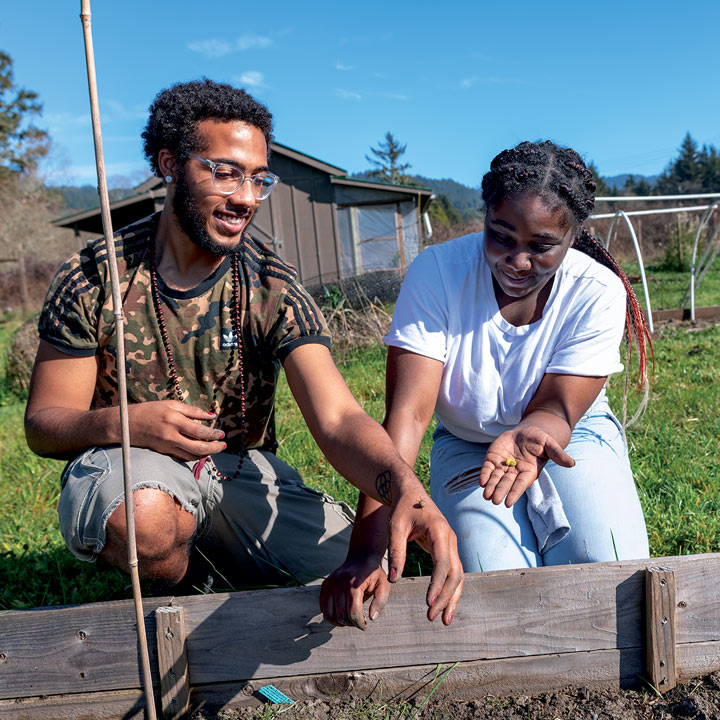 two black students working in a garden bed