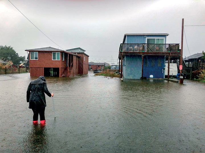 Student measuring water levels in a flood