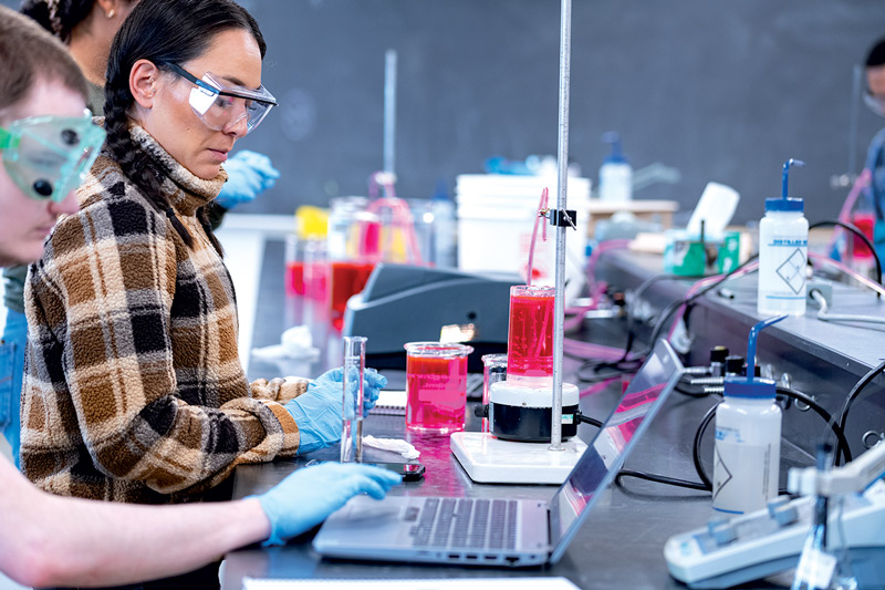 Students in a science lab with computers and chemistry equipment