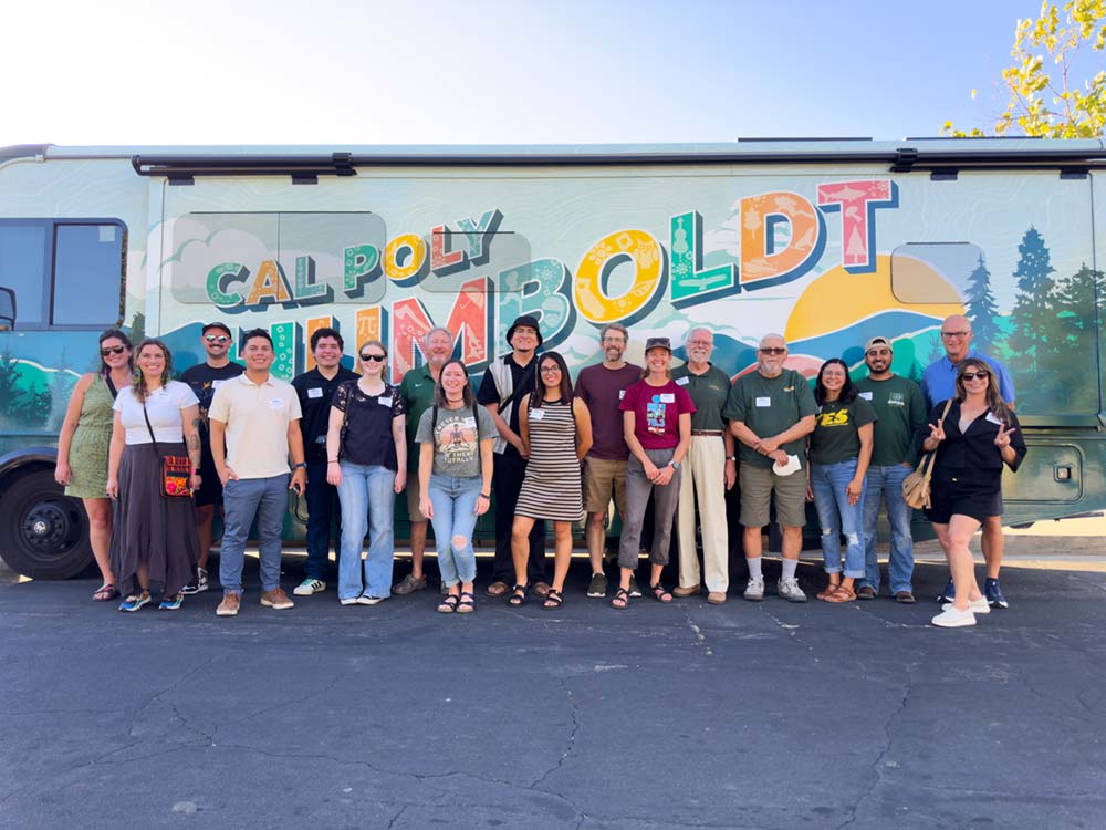 People holding Cal Poly Humboldt pennants