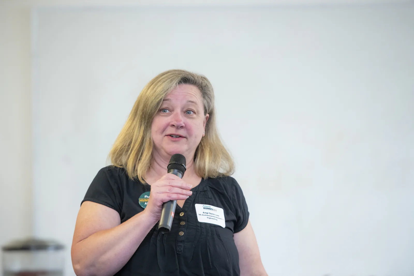 Angelique Sorensen speaks into a microphone during the Alumni Connections event.