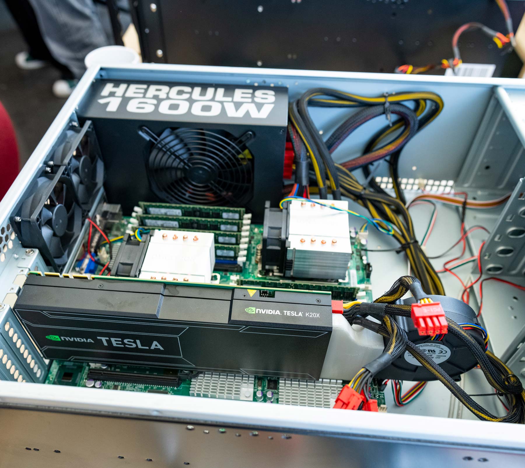 Students and faculty work with computer equipment in a campus lab.