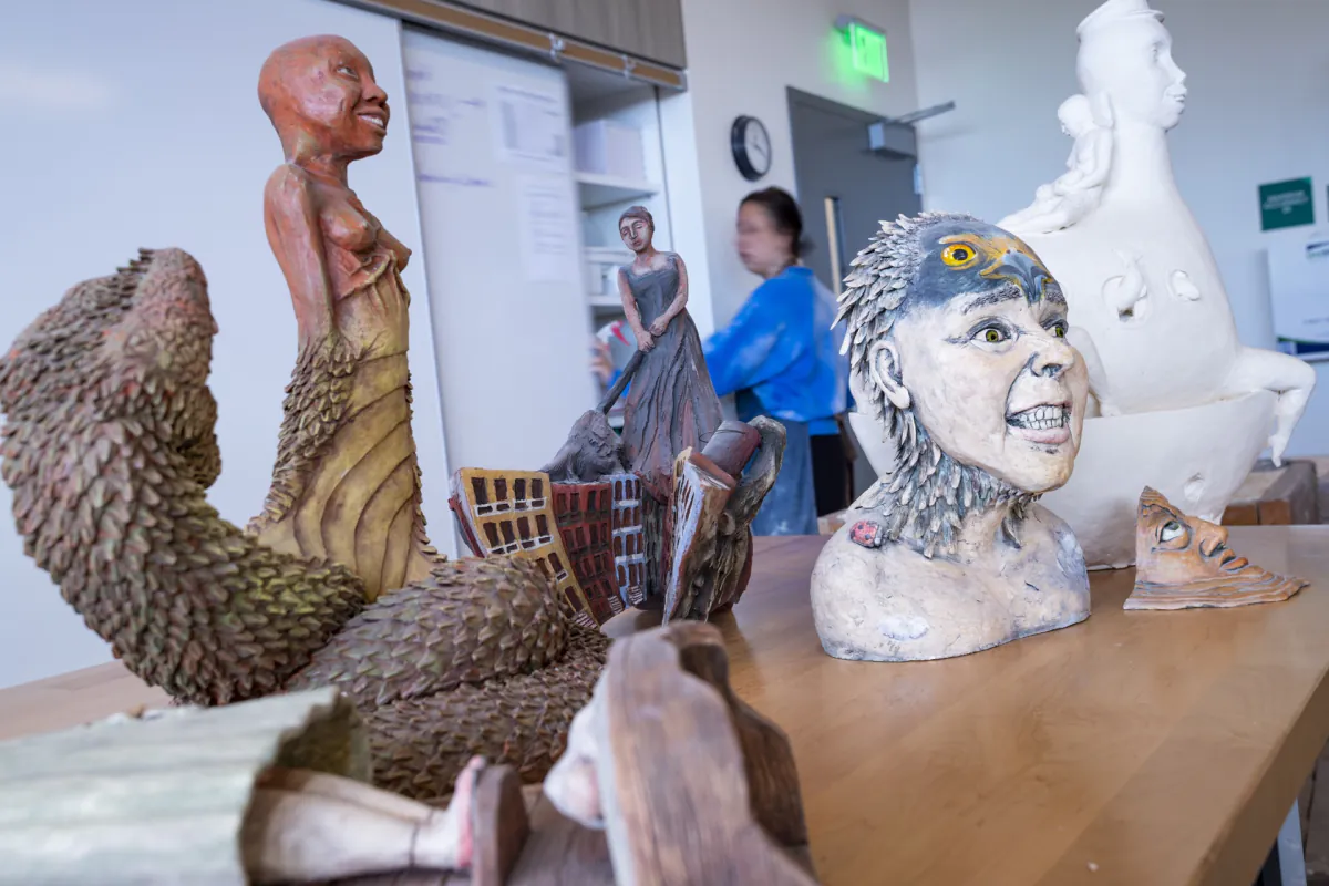 Finished ceramic sculptures arranged on a studio table in Jenkins Hall