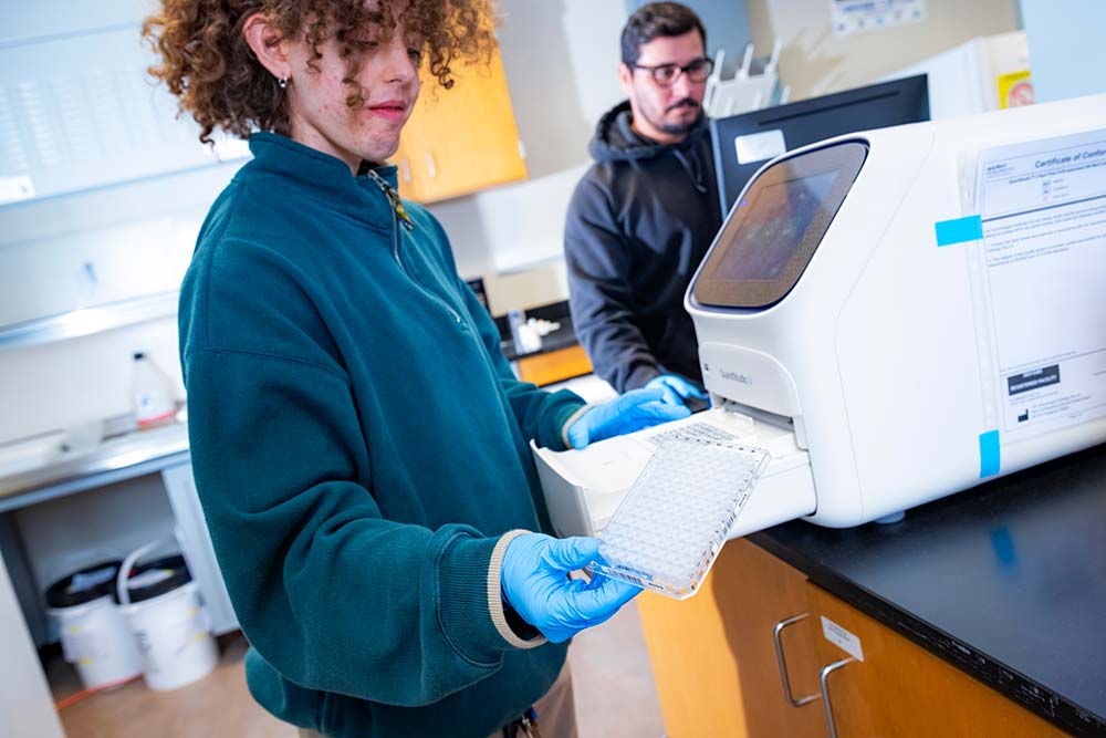 Researcher working with water-testing equipment in a laboratory
