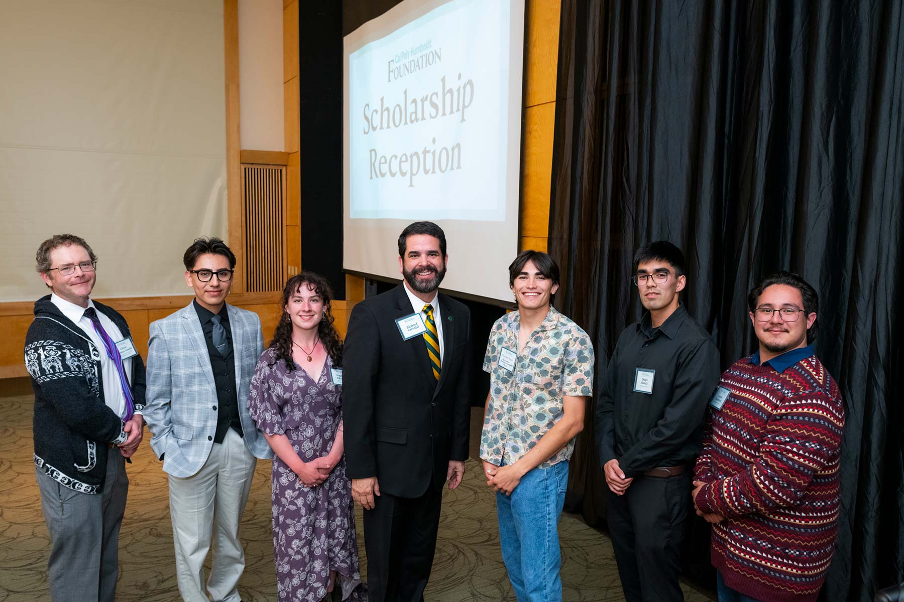 Richard Carvajal stands with scholarship recipients at a scholarship reception.