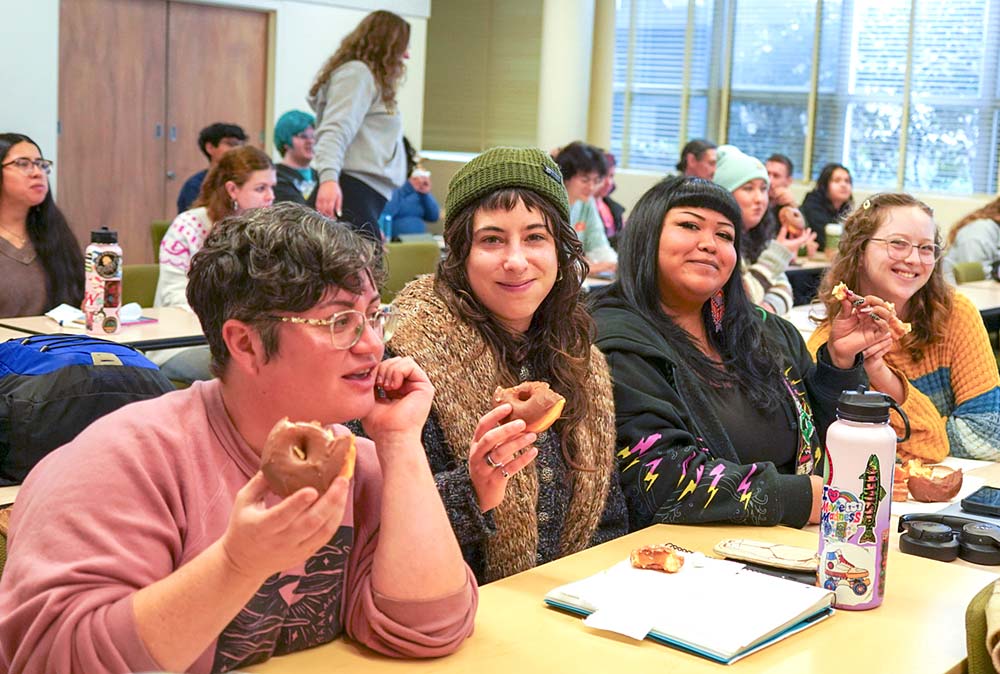 Students eating doughnuts in a classroom