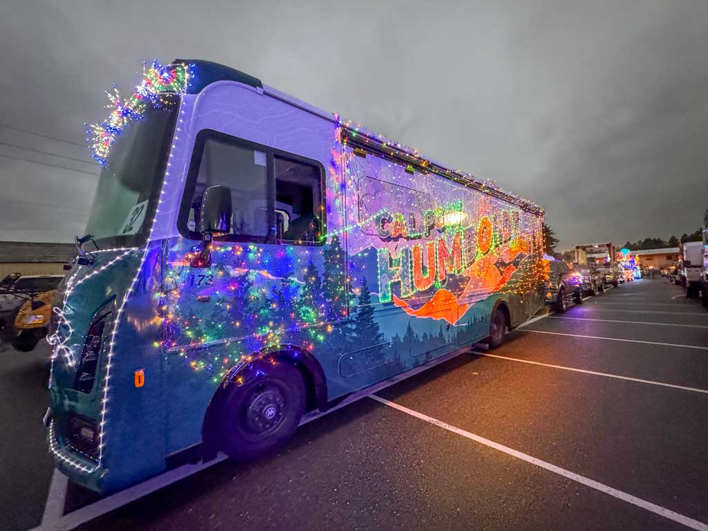 The Mobile Alumni Center decorated with holiday lights in a truck parade