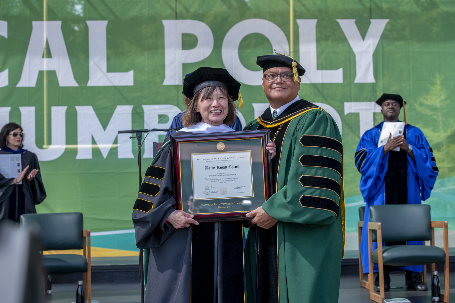 Betty Kwan Chinn receiving an honorary degree presented by Cal Poly Humboldt President Tom Jackson, Jr.