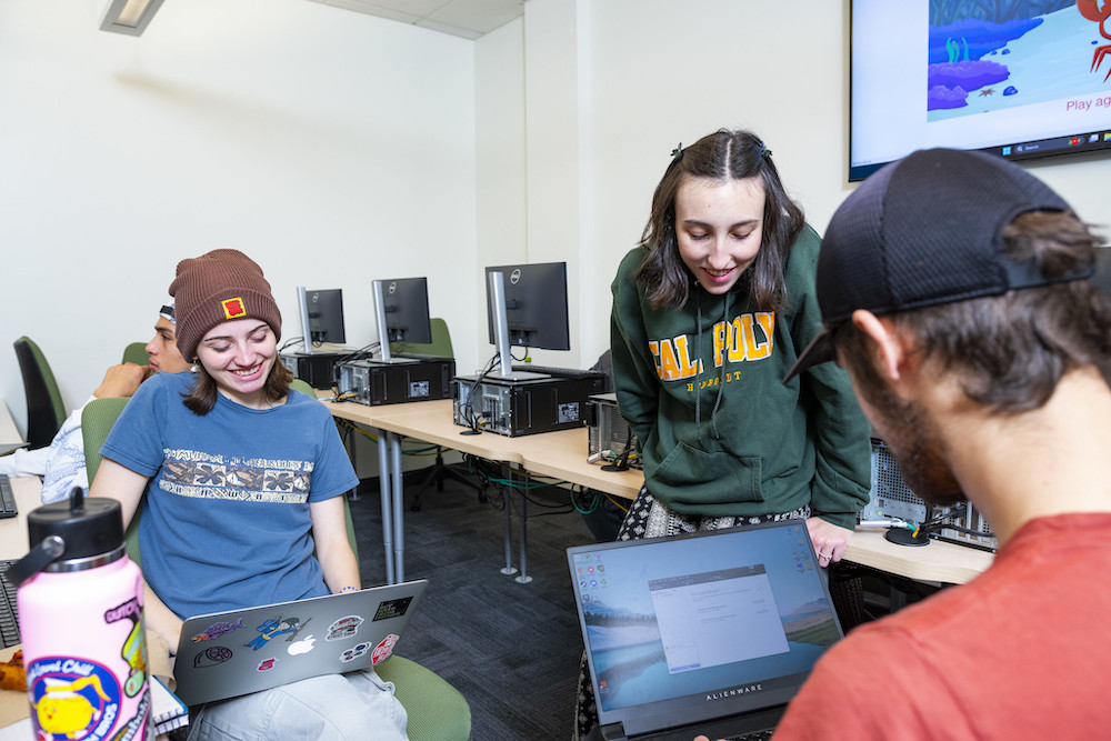 students gather around computers