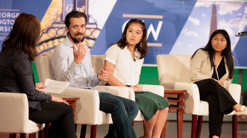 A photo of Eva Sideris sitting in a panel discussion during the 2023 Planet Forward conference.