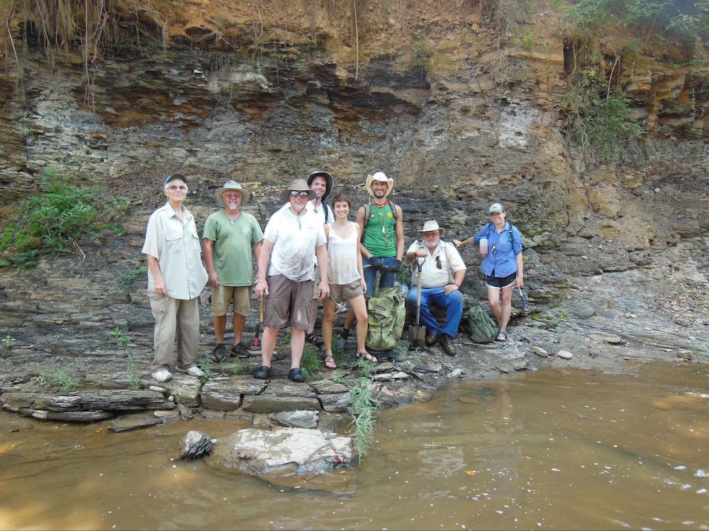 researchers standing on the riverbank 