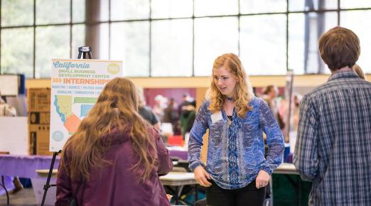 A photo of students speaking with an employer at the Career Expo