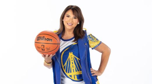 A photo of Liz Pimentel in her Golden State Warriors Hardwood Classics dance team uniform holding a basketball. 