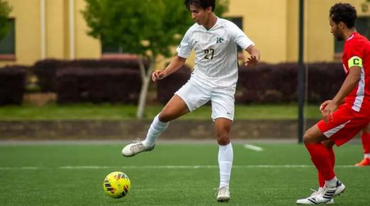 A photo of Cal Poly Humboldt Soccer Player Erwin "EJ" Manibusan playing soccer. 