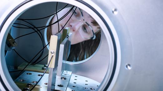 female looks through tunnel in Cal Poly Humboldt's Gravity Lab.