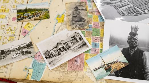 old photos, including a black and white photo of an Indigenous man, lay across an aging map of Humboldt County. 