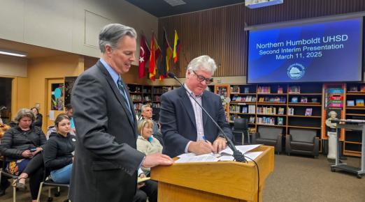 A photo of Cal Poly Humboldt Interim President Michael Spagna and Northern Humboldt Union High School District Superintendent Roger Macdonald signing the MOU for direct admissions to the University. 