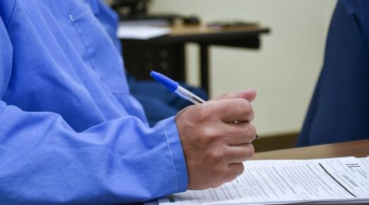 student taking notes on a resume 