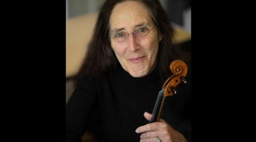 A photo of Carla Shapreau holding a violin. Photo by Max Thill