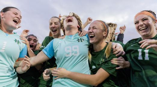 members of the women's soccer team celebrating CCAA win