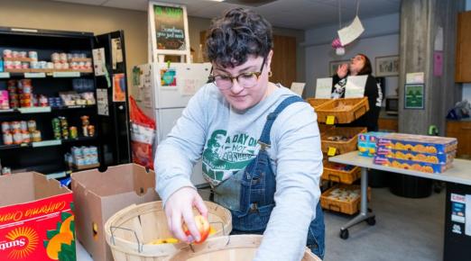 A photo of a volunteer sorting food at the Oh SNAP! Food Pantry. 