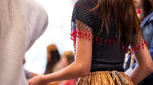 A photo of a the back of a dancer at during a Big Time event. 
