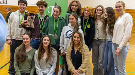 A group of students standing side by side smiling 