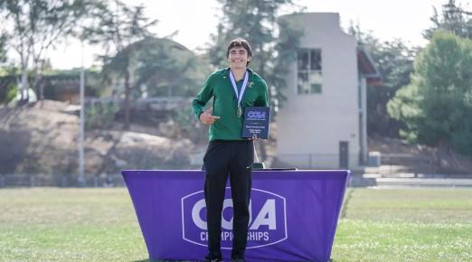 Pole vaulter Michael Payan stands proudly with "Field Athlete of the Meet" plaque. 