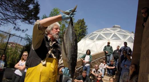 A photo of Fisheries Biology Professor Terry Roelofs holding a tuna fish during a fisheries class.