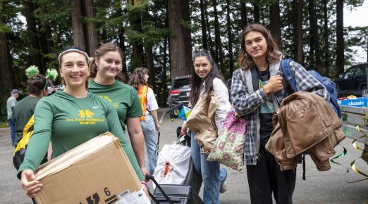 Student athletes helping carry boxes for incoming students into the campus residences. 