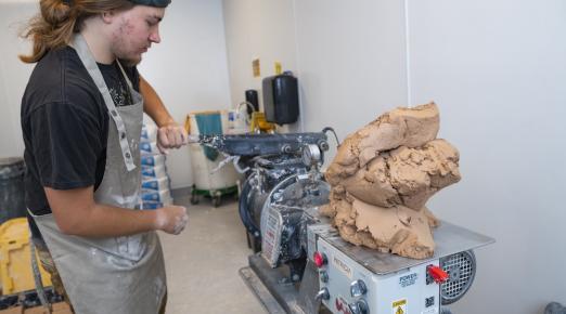 Ceramics student Liam Henslee working in the clay recycling room at Jenkins Hall 