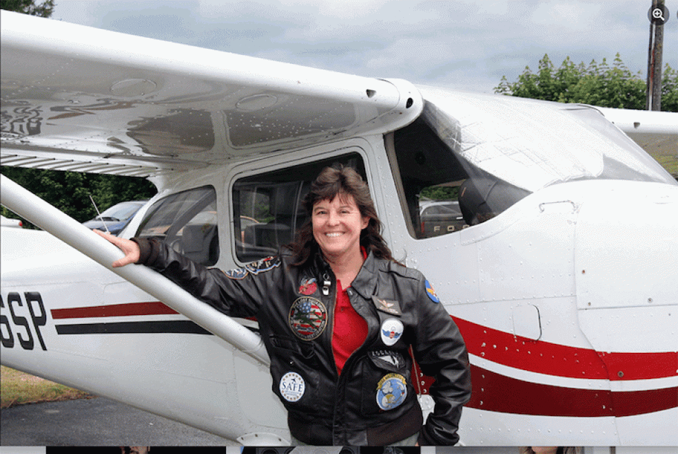 Meg Godlewski standing in front of a small plane.
