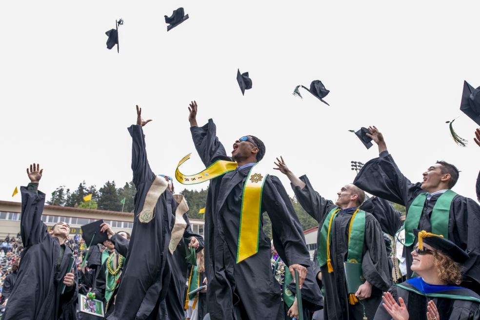 grads tossing hats in the air