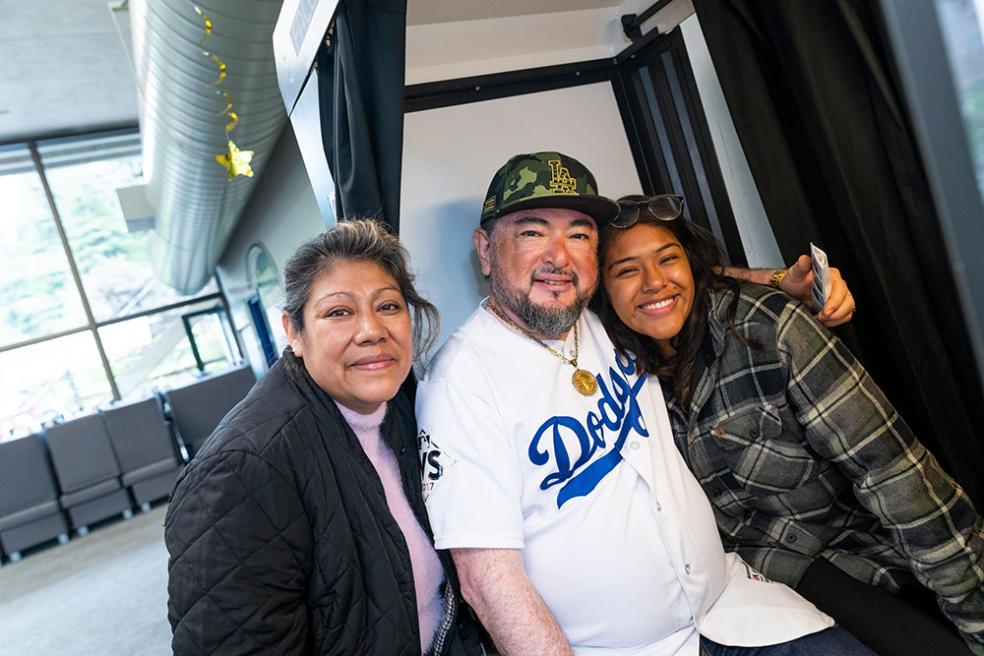 Ruth Espinosa poses with her family at the Housing move-in photo booth.