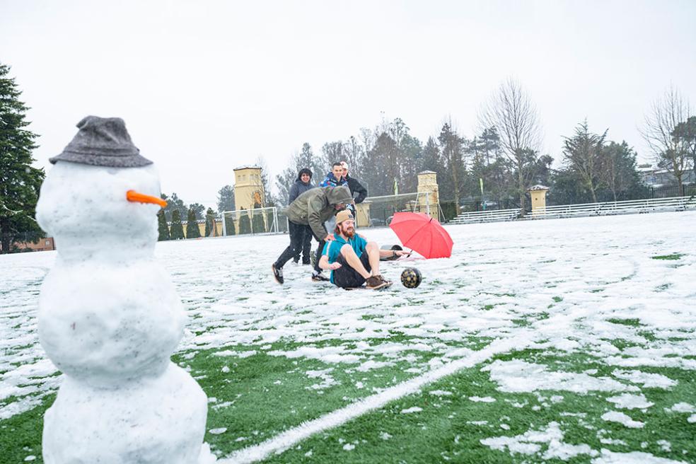 Students play in the snow in College Creek field