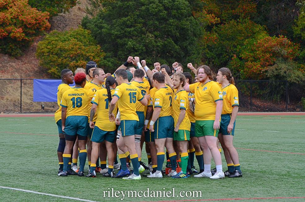 A photo of the Fall 2023 Humboldt Men's Rugby team cheering before a match. Photo by Riley McDaniel