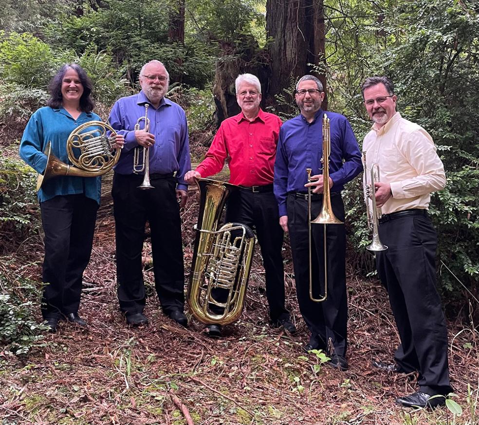 A photo of musicians holding percussion instruments. 