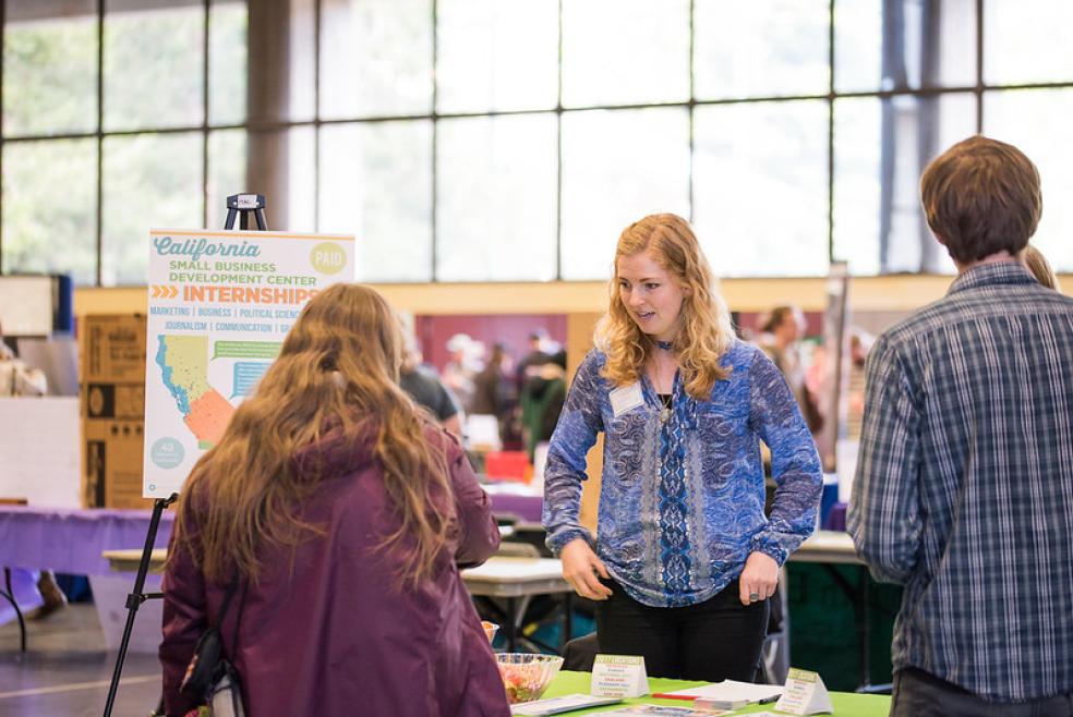 A photo of students speaking with an employer at the Career Expo