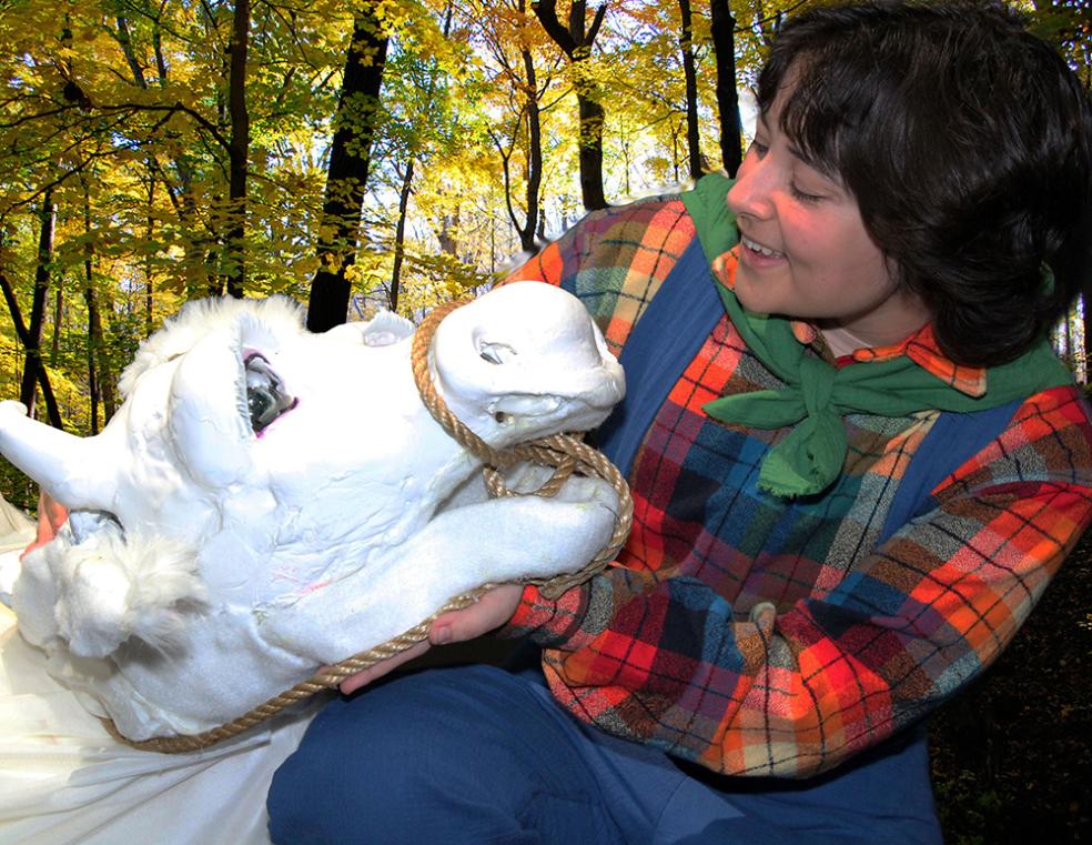 A photo of student Ash Quintana as Jack from Jack and the Beanstalk with Milky the cow from "Into the Woods"