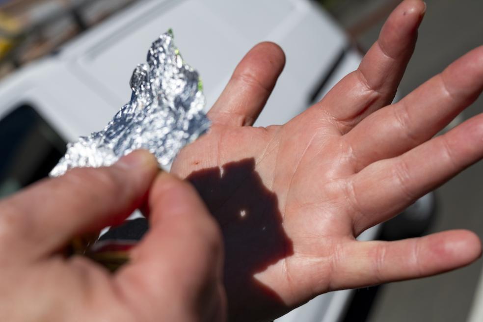 Tin foil and a hand come in handy during the eclipse.