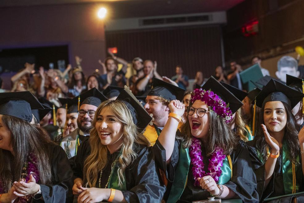 A photo of graduates at the College of Professionals Studies Commencement Ceremony hosted at the Eureka Theater. 