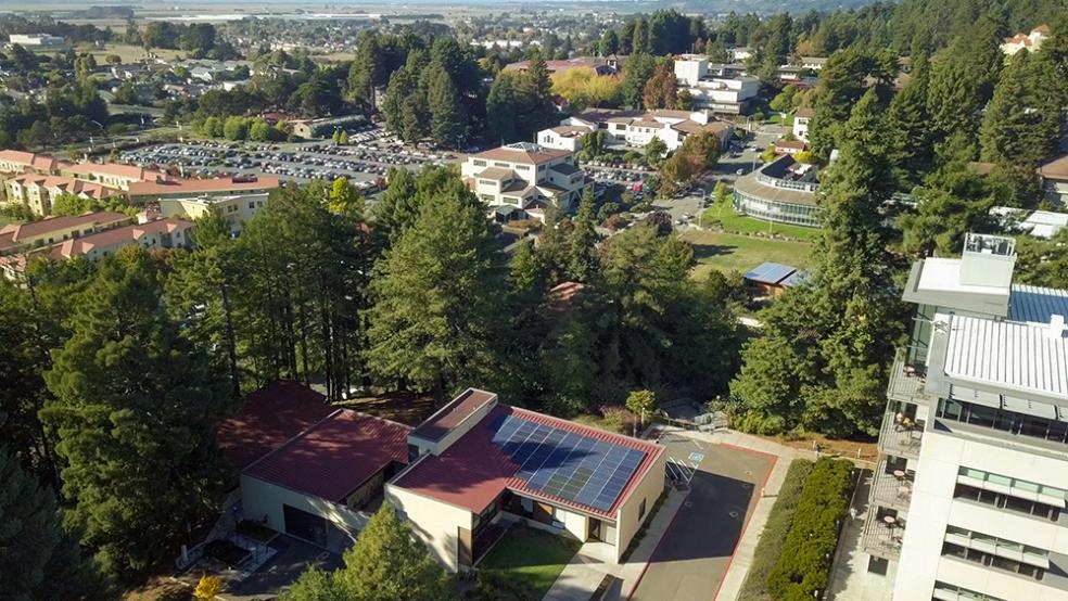 Aerial view of campus showing solar arrays on the roof of Schatz Energy Research Center in the foreground.